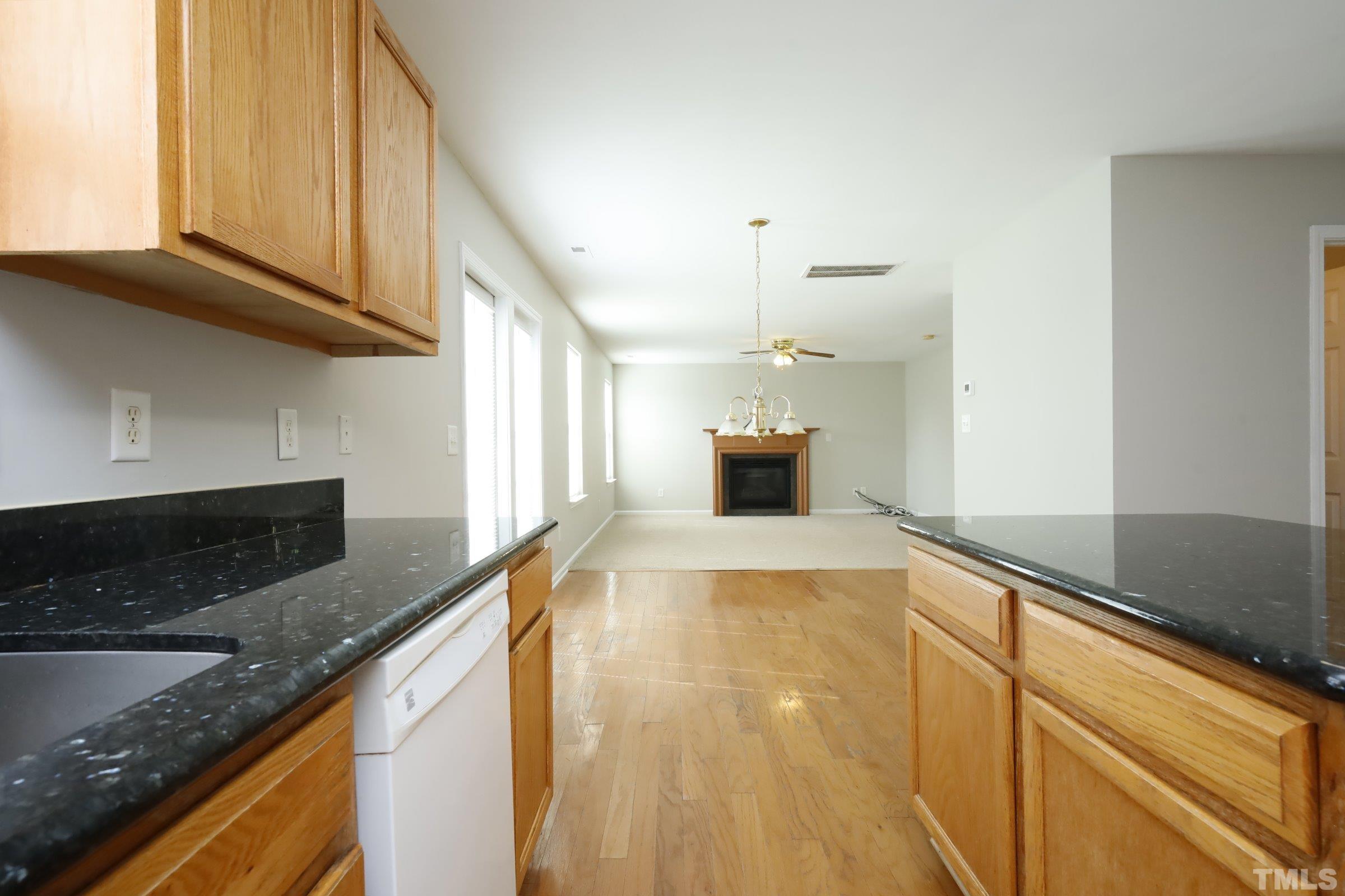 4014 Springfield Creek Drive Raleigh, NC 27616 - Photo 14 of 36 a view of large kitchen with granite countertop lots of counter space and wooden floor