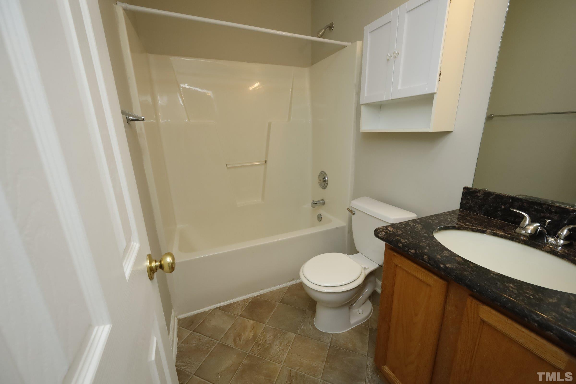 4014 Springfield Creek Drive Raleigh, NC 27616 - Photo 22 of 36 a bathroom with a sink toilet and shower