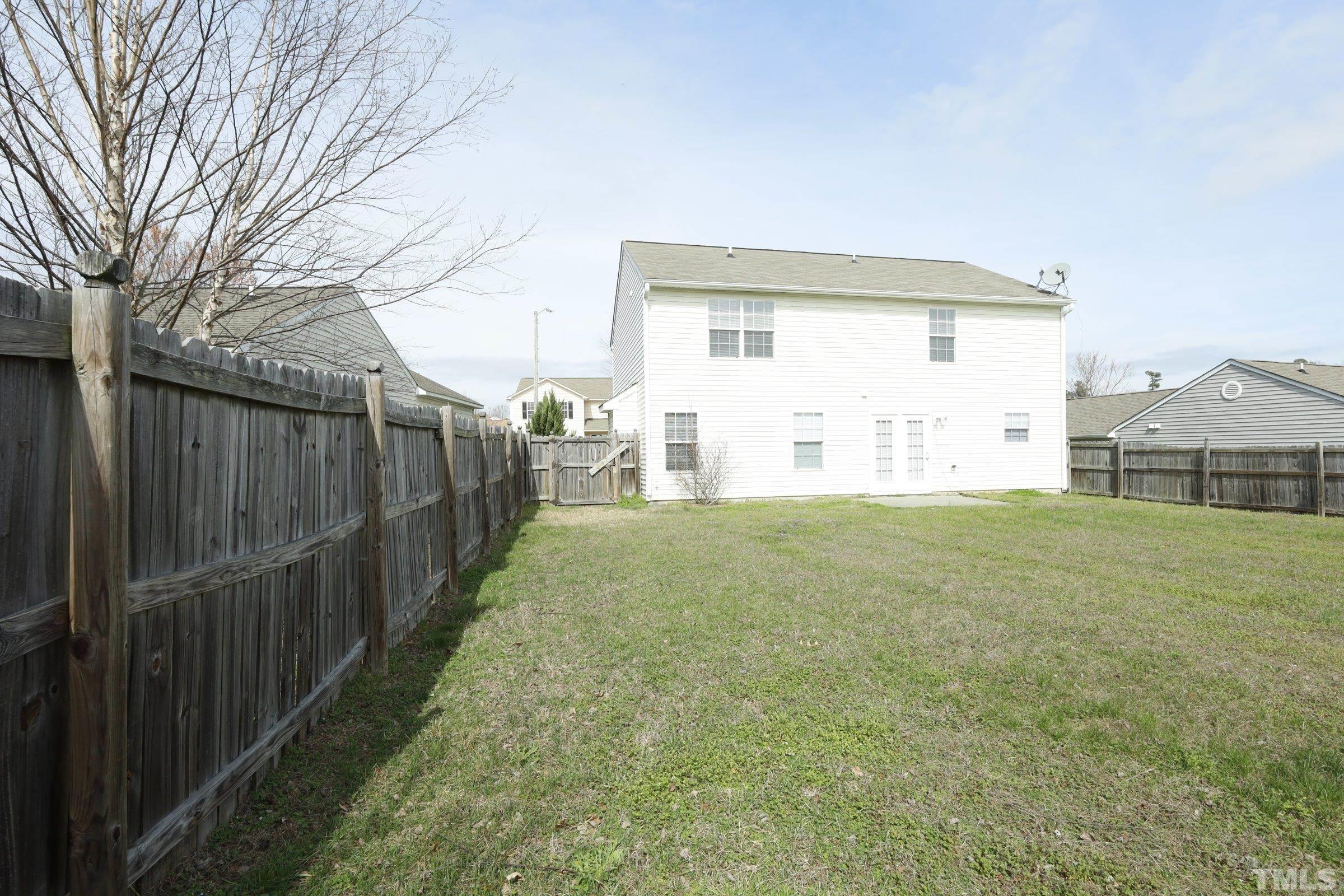 4014 Springfield Creek Drive Raleigh, NC 27616 - Photo 31 of 36 a view of a backyard with wooden fence