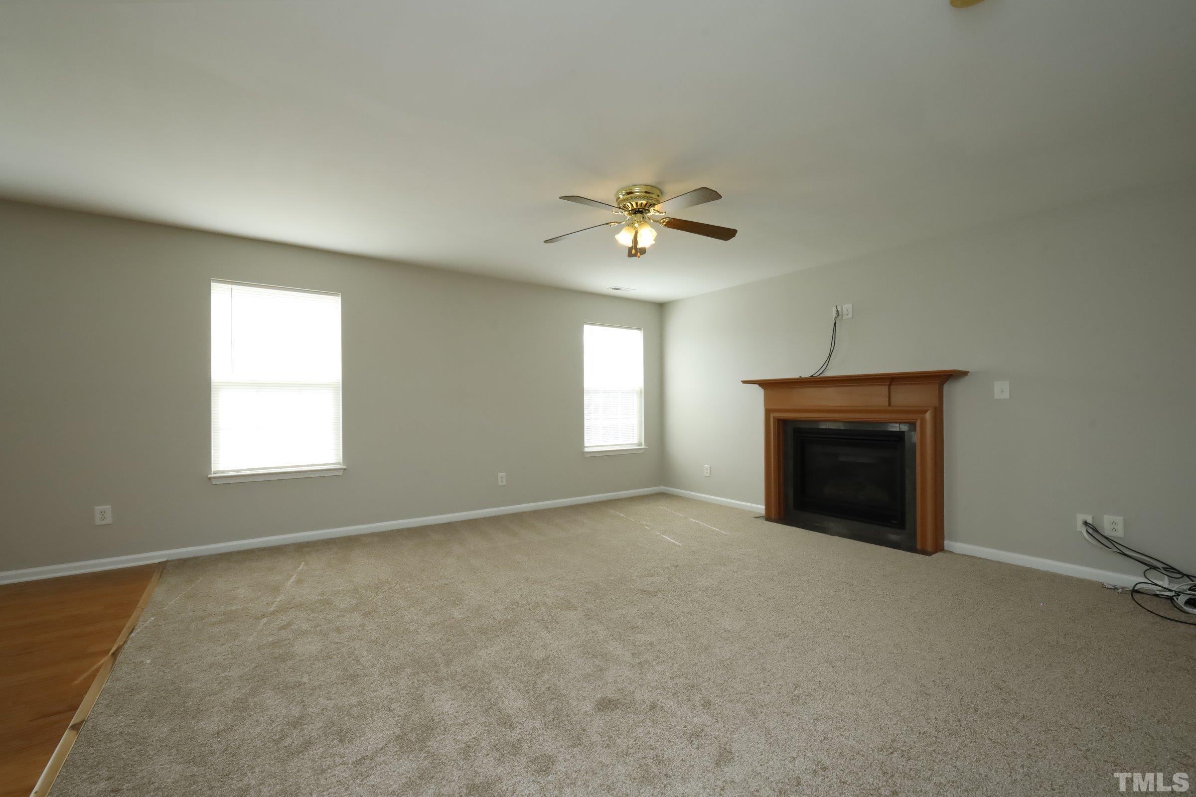 4014 Springfield Creek Drive Raleigh, NC 27616 - Photo 5 of 36 an empty room with windows and fireplace