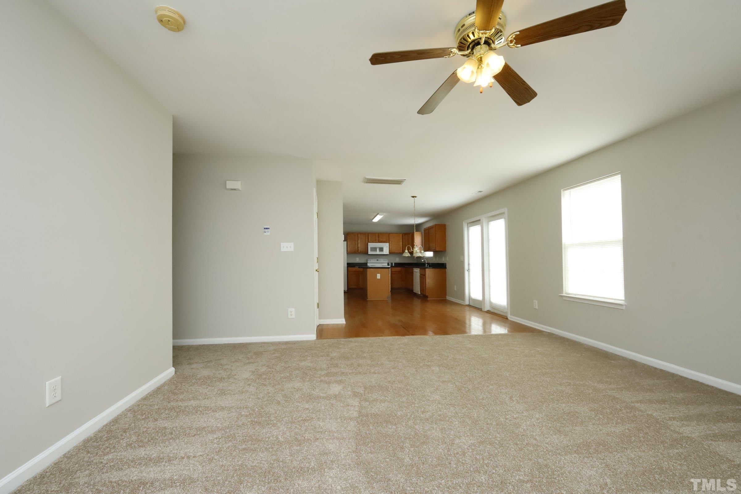 4014 Springfield Creek Drive Raleigh, NC 27616 - Photo 7 of 36 a view of empty room with wooden floor and fan