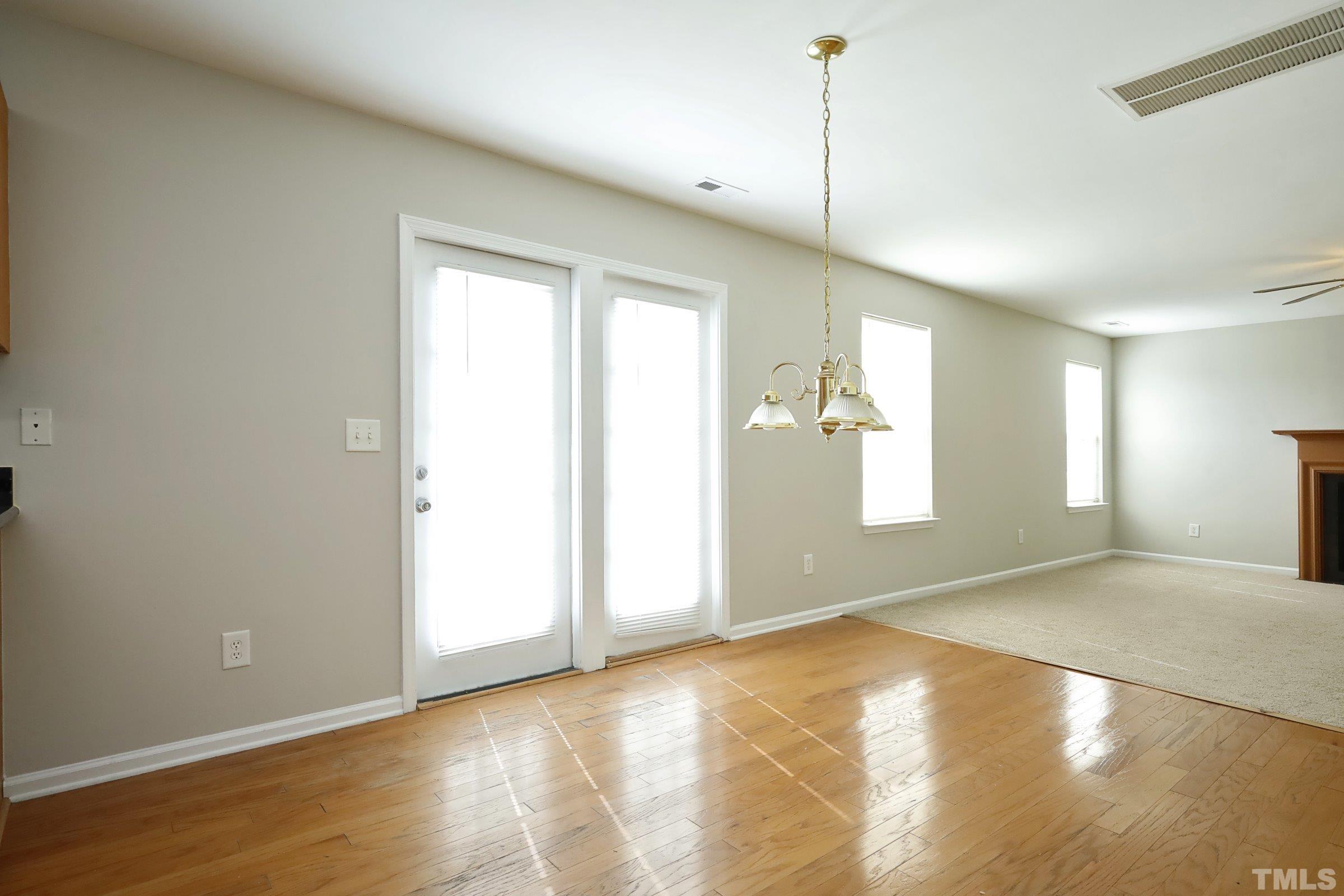 4014 Springfield Creek Drive Raleigh, NC 27616 - Photo 9 of 36 a view of empty room with wooden floor and fan