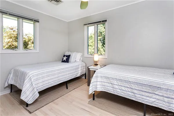 a bedroom with a bed lamp and window