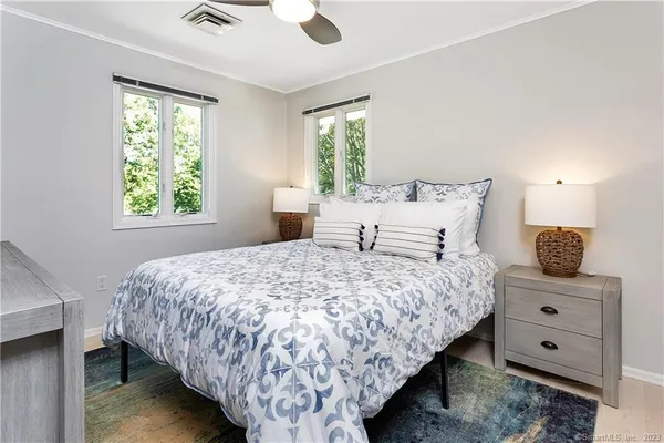 a bedroom with a bed and window