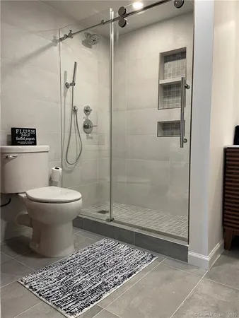 a bathroom with a toilet and a shower