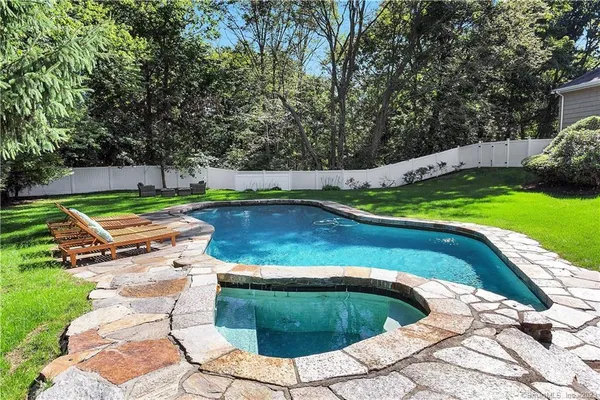 a view of a backyard with swimming pool