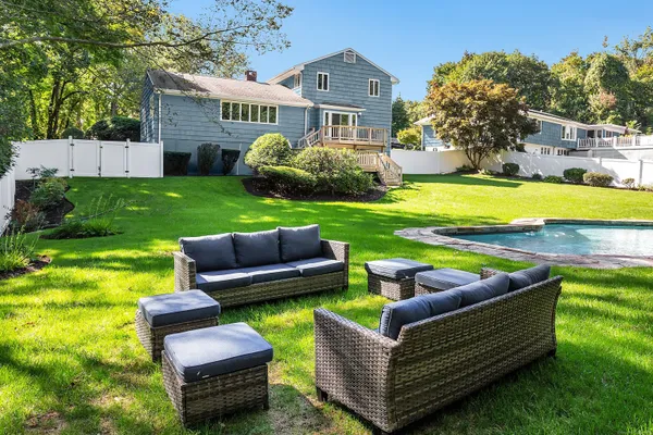 a front view of a house with yard and green space