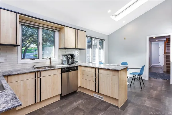 a kitchen with a sink cabinets and window