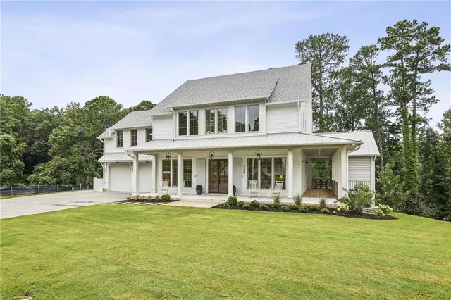 a front view of a house with a yard table and chairs
