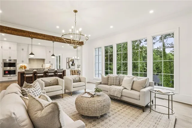 a living room with furniture chandelier and a fireplace