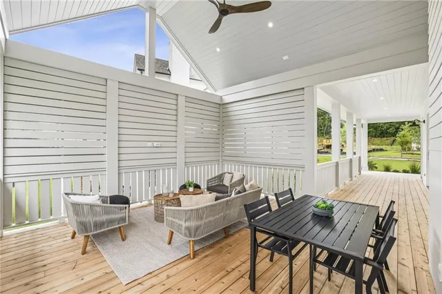 a balcony with couple of chairs and a wooden floor
