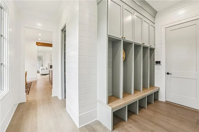 a view of a hallway with entryway and wooden floor