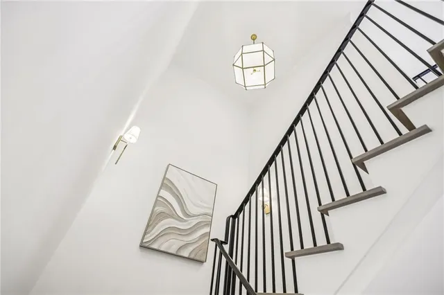 a spacious bedroom with a bed and a wooden floor