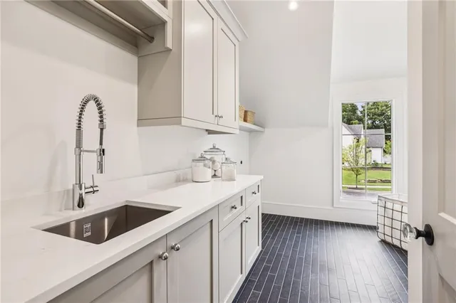 a bathroom with a sink a toilet and a mirror