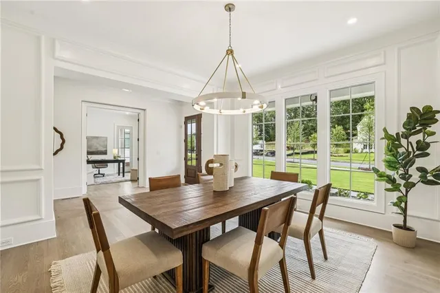 a view of a a dining room with furniture window and wooden floor
