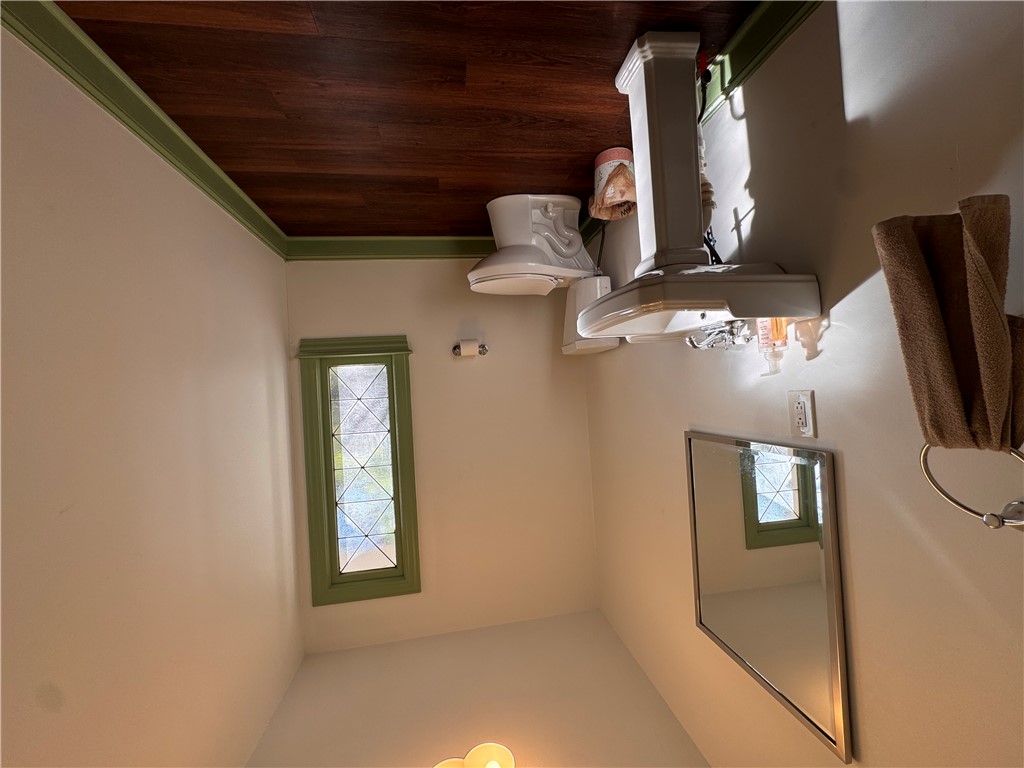2211 East River Street Anderson, SC 29621 - Photo 33 of 40 This bathroom features unique window details and rich wood flooring, offering a distinct aesthetic.