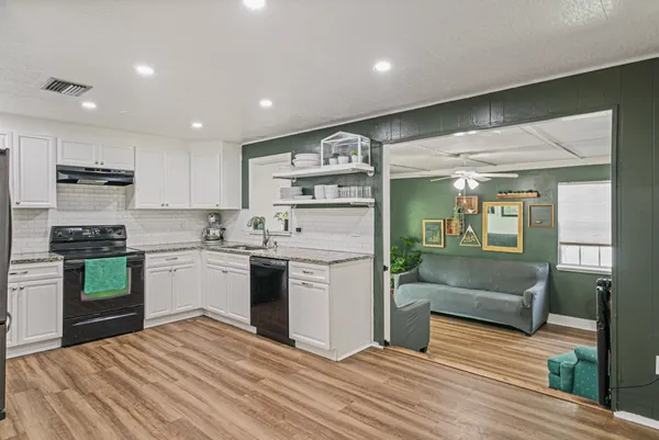 a kitchen with a refrigerator and a sink