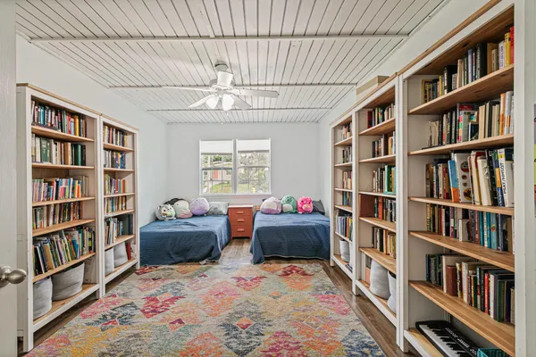 a living room with furniture and a book shelf