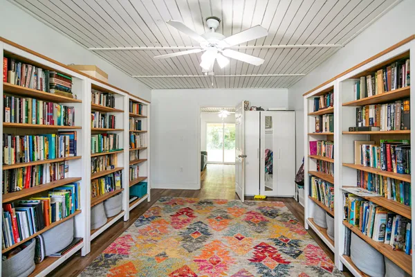 a bedroom with a bed and a book shelf