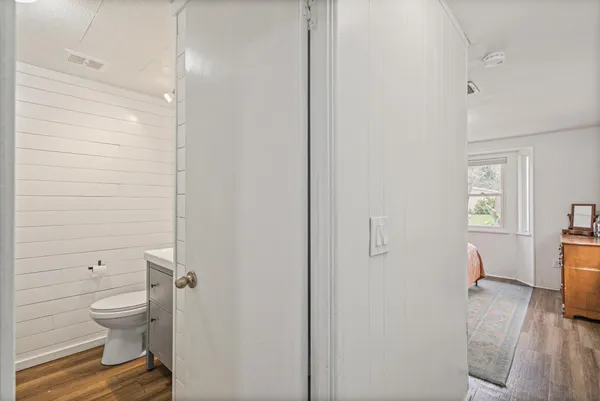 a bathroom with a toilet and a shower