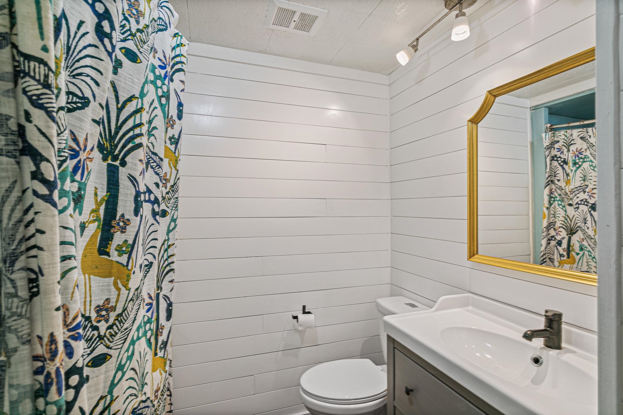 963 Catalina Road St. Augustine, FL 32086 - Photo 27 of 59 a bathroom with a toilet sink and mirror