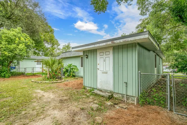 a backyard of a house with plants and tree