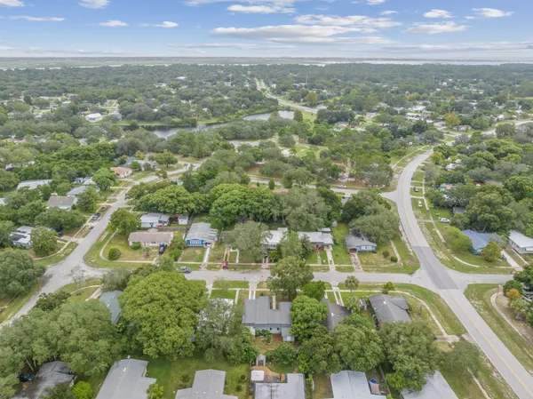 an aerial view of residential houses with city view