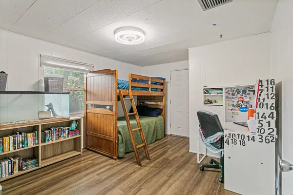 a bedroom with furniture and a book shelf