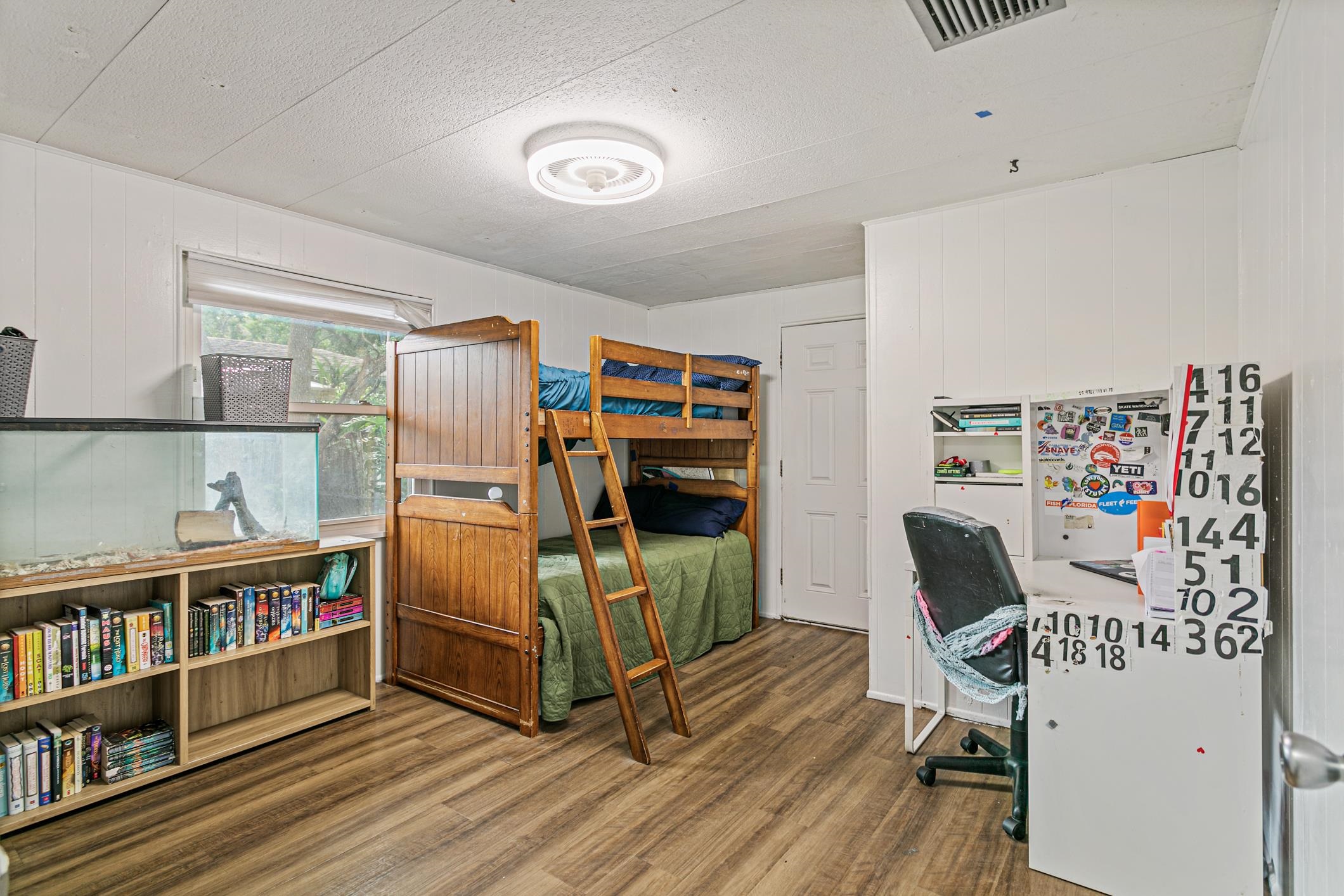 963 Catalina Road St. Augustine, FL 32086 - Photo 4 of 59 a bedroom with furniture and a book shelf