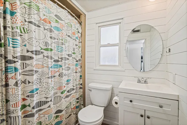 a bathroom with a sink toilet and shower