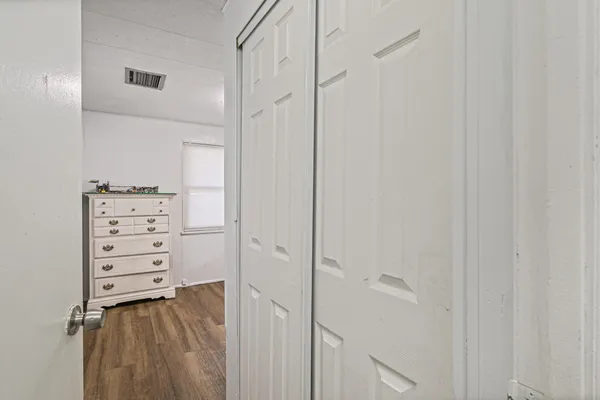 a view of walk in closet with clothes