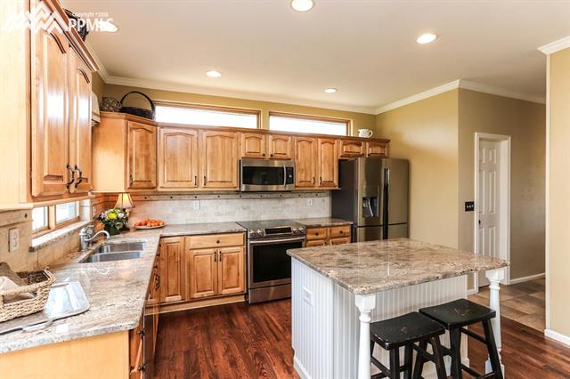 42745 Pearson Ranch Loop Parker, CO 80138 - Photo 6 of 36 Kitchen with Granite Countertops, Stainless Appliances and Walk-In Pantry
