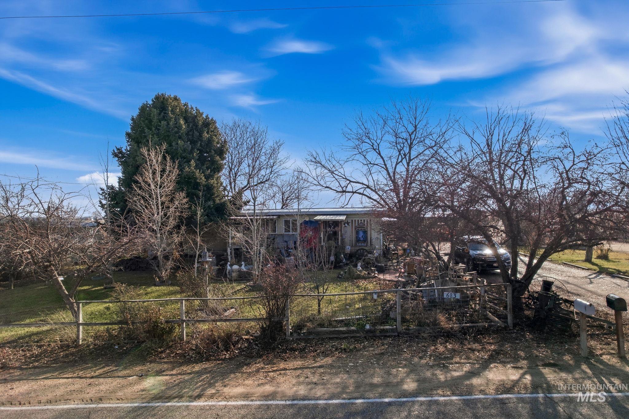 603 East King Road Kuna, ID 83634 - Photo 2 of 22 View of property hidden behind natural elements featuring a fenced front yard