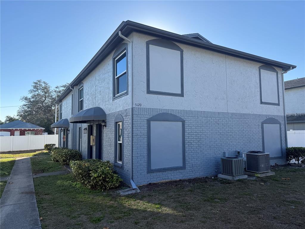 5120 East Temple Heights Road, Unit D Tampa, FL 33617 - Photo 1 of 14 a front view of a house with garden