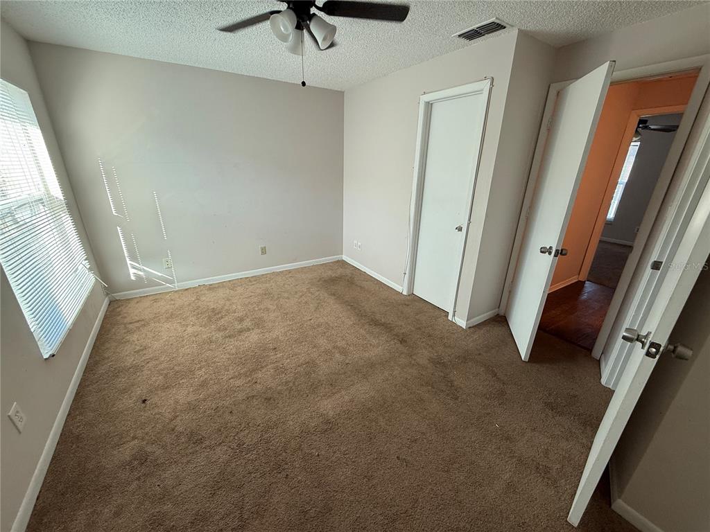 5120 East Temple Heights Road, Unit D Tampa, FL 33617 - Photo 13 of 14 an empty room with a window