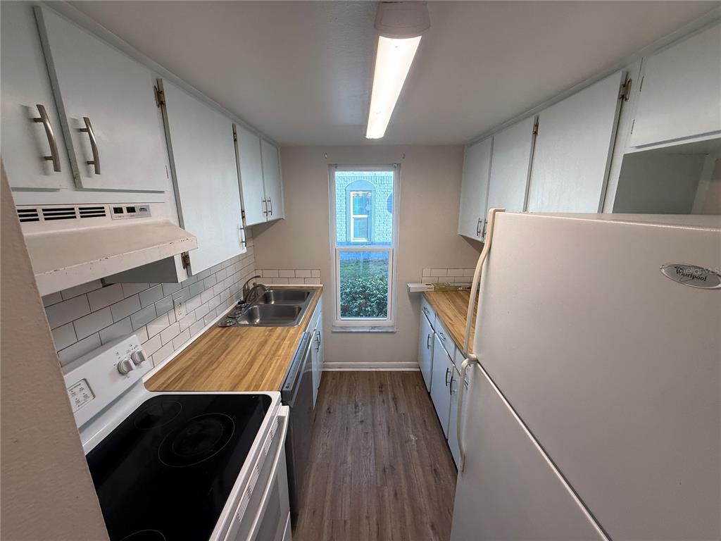5120 East Temple Heights Road, Unit D Tampa, FL 33617 - Photo 3 of 14 workspace with wooden floor washer and dryer