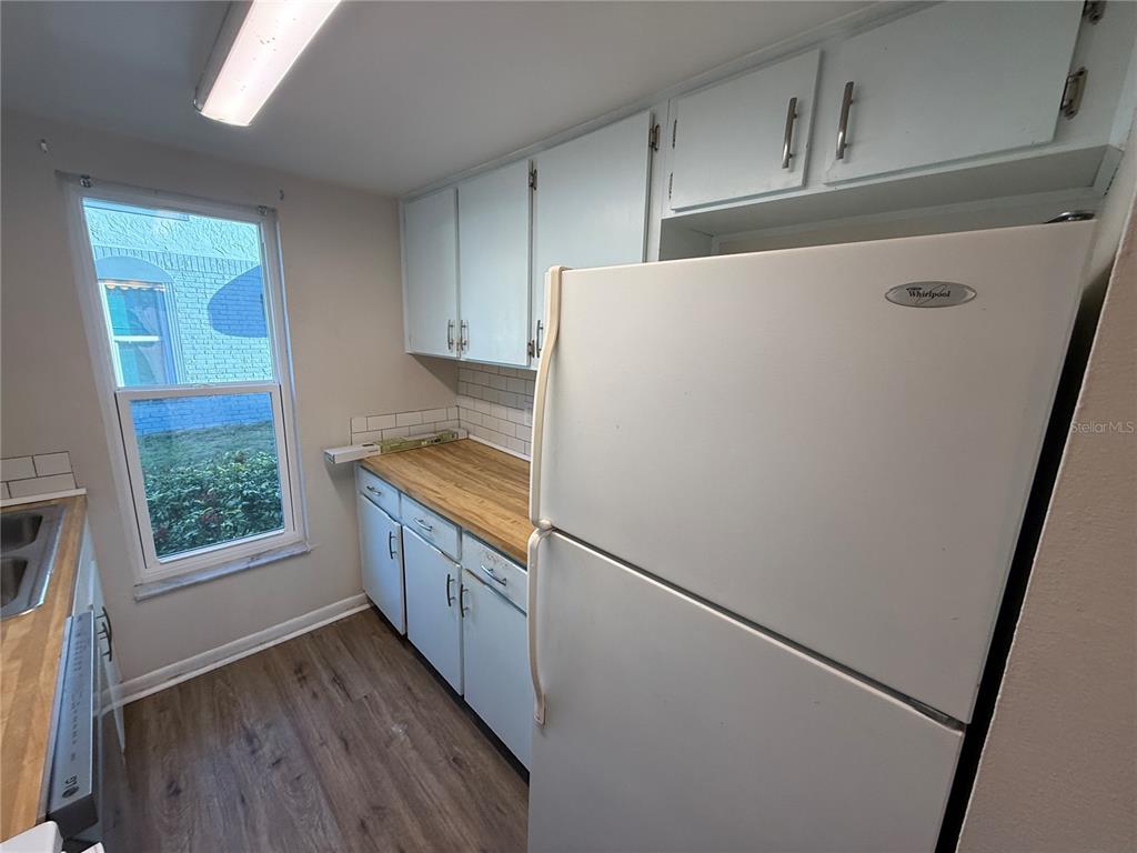 5120 East Temple Heights Road, Unit D Tampa, FL 33617 - Photo 5 of 14 a kitchen with a refrigerator and a sink