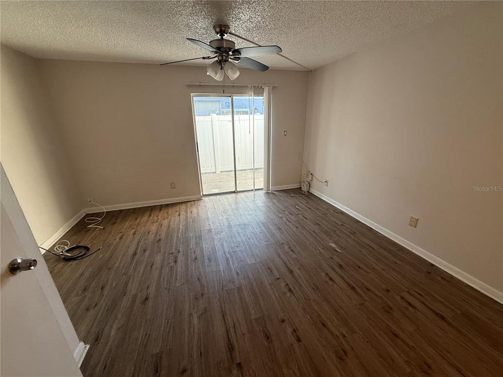 5120 East Temple Heights Road, Unit D Tampa, FL 33617 - Photo 7 of 14 wooden floor in an empty room with a window
