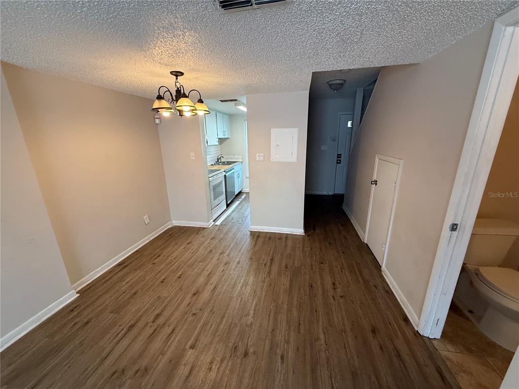 5120 East Temple Heights Road, Unit D Tampa, FL 33617 - Photo 9 of 14 a view of a livingroom with wooden floor