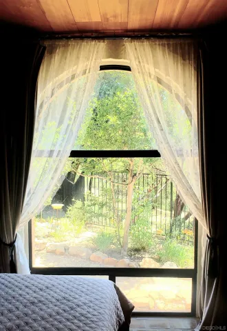 a view of a room with wooden floor and a window