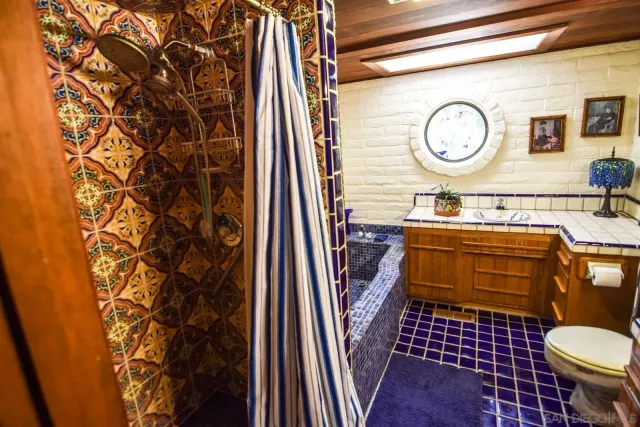 a bathroom with a sink toilet a mirror and vanity