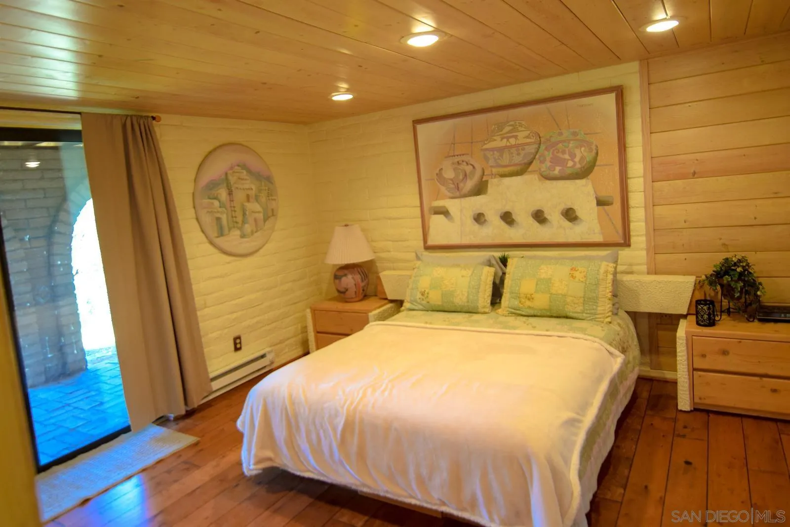 23684 Viejas Grade Road Descanso, CA 91916 - Photo 30 of 54 a bedroom with a bed and a wall painting