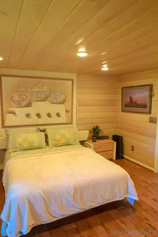 a bedroom with a bed and cupboard