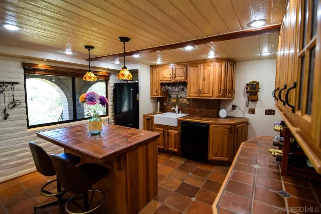 a kitchen with stainless steel appliances granite countertop a refrigerator a sink and a stove