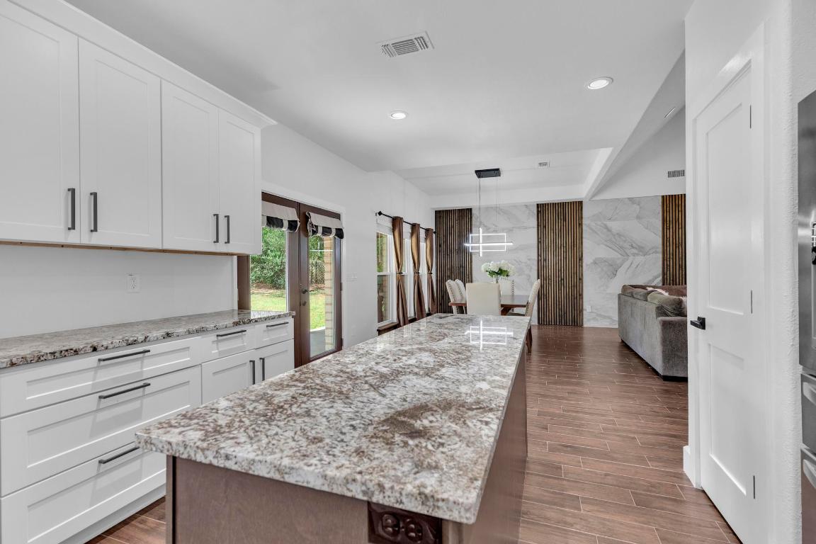 326 Coventry Road Spicewood, TX 78669 - Photo 13 of 30 a kitchen with refrigerator and cabinets