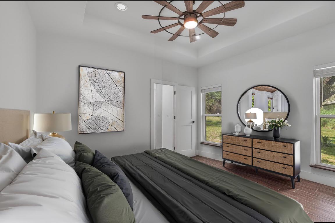 326 Coventry Road Spicewood, TX 78669 - Photo 16 of 30 a bed room with bed and a chandelier