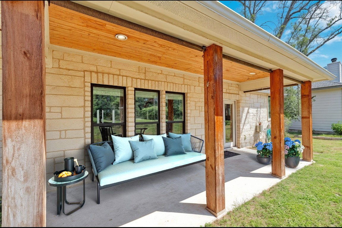 326 Coventry Road Spicewood, TX 78669 - Photo 27 of 30 a view of living room kitchen with furniture and floor to ceiling window