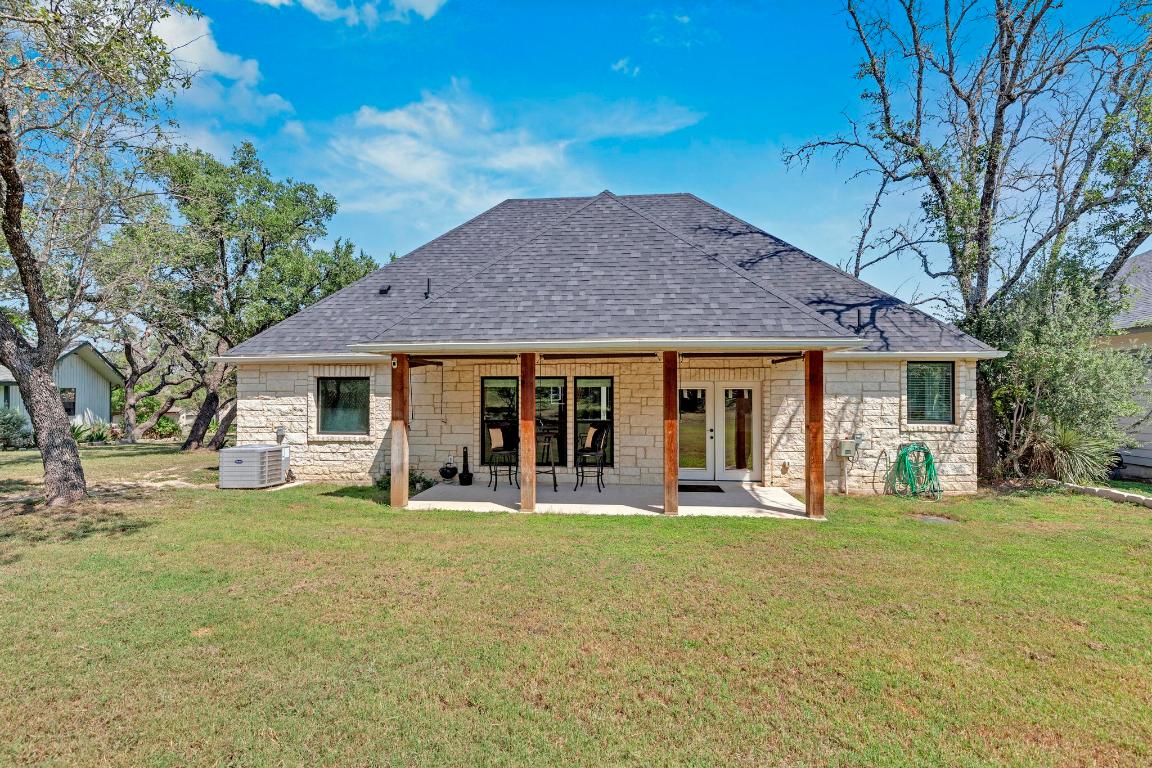 326 Coventry Road Spicewood, TX 78669 - Photo 28 of 30 a front view of a house with a garden and trees
