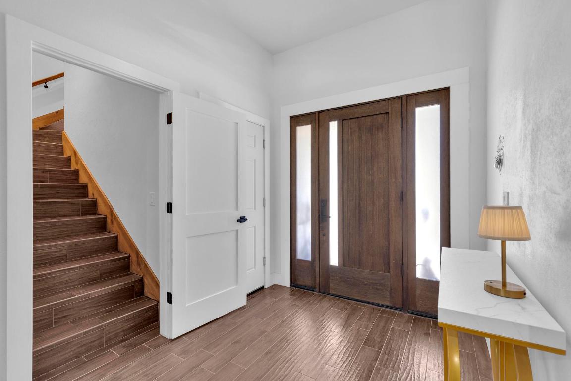326 Coventry Road Spicewood, TX 78669 - Photo 10 of 30 a view of a room with wooden floor lounge chair and a window