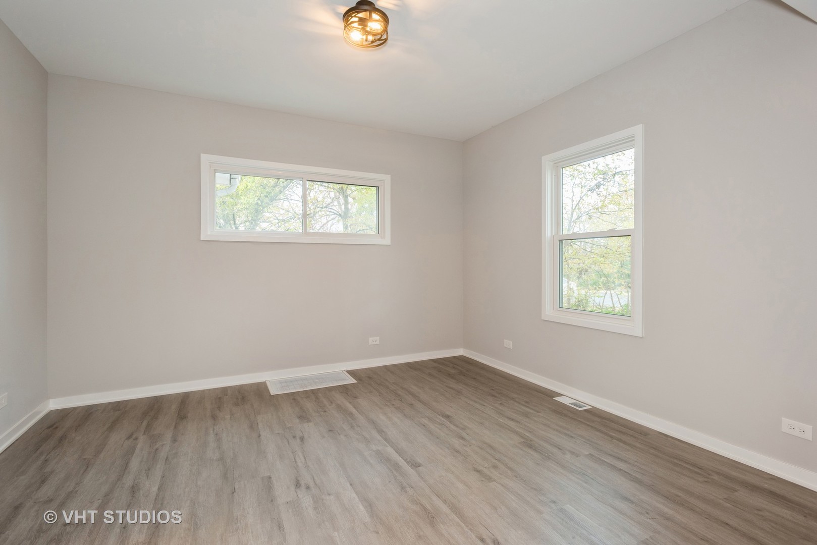 381 Sullivan Road North Aurora, IL 60542 - Photo 11 of 29 an empty room with wooden floor and windows